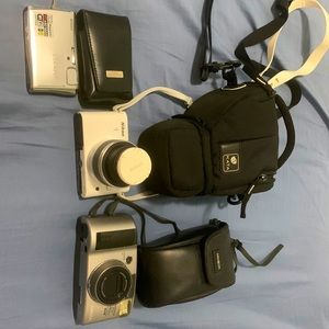 Cameras: Nikon Coolpix camera, Nikon 1 camera, Freedom zoom Minolta camera.